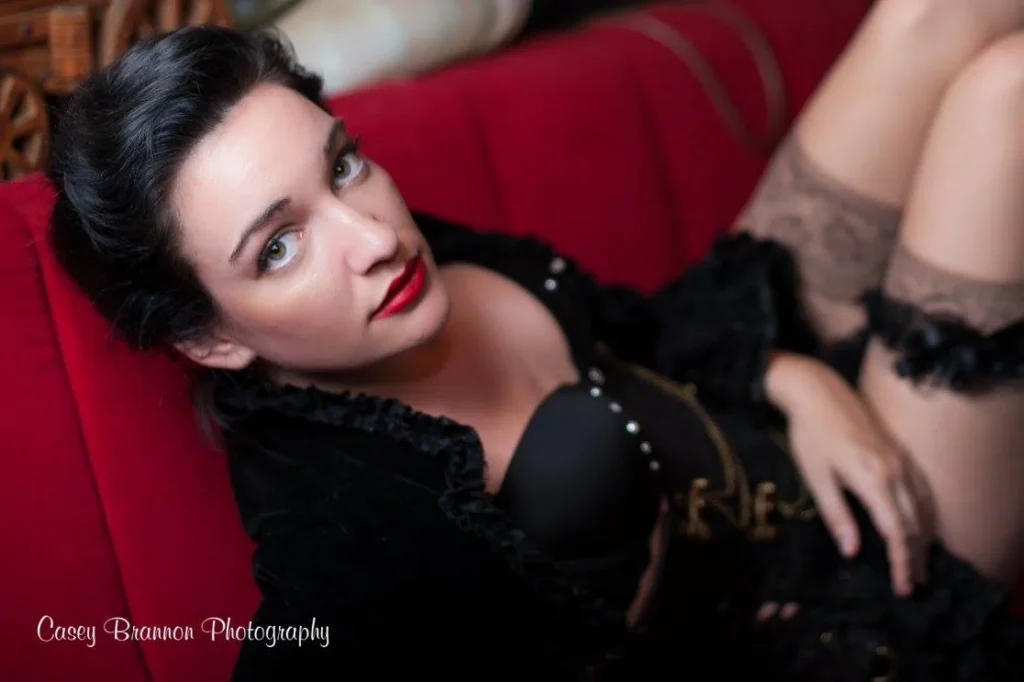 Boudoir portrait on a red sofa