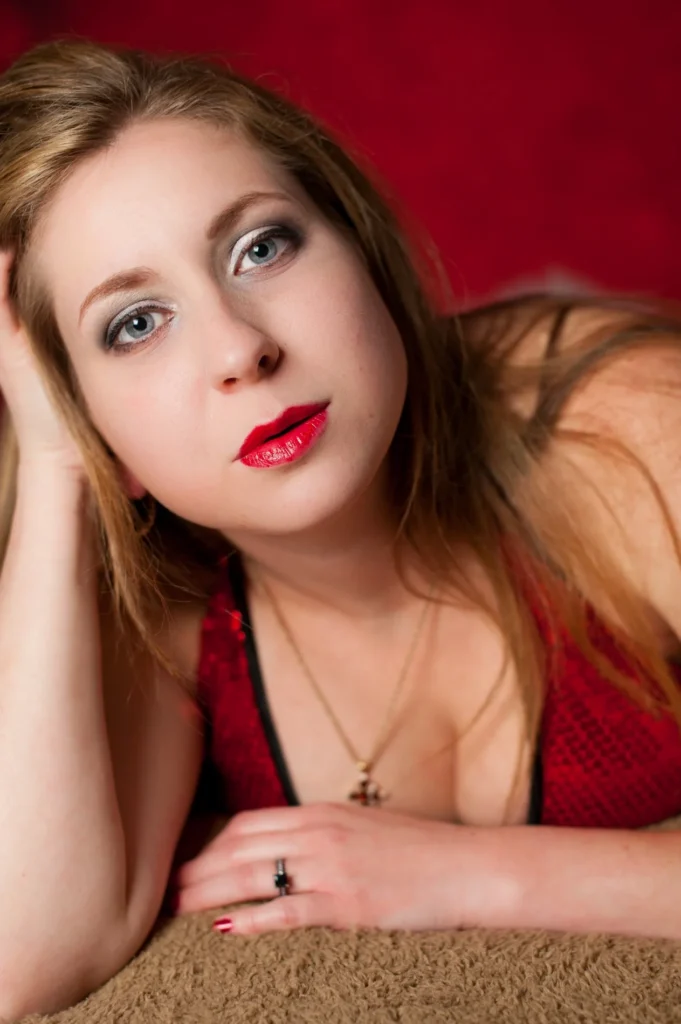 Portrait with red lipstick against a red background