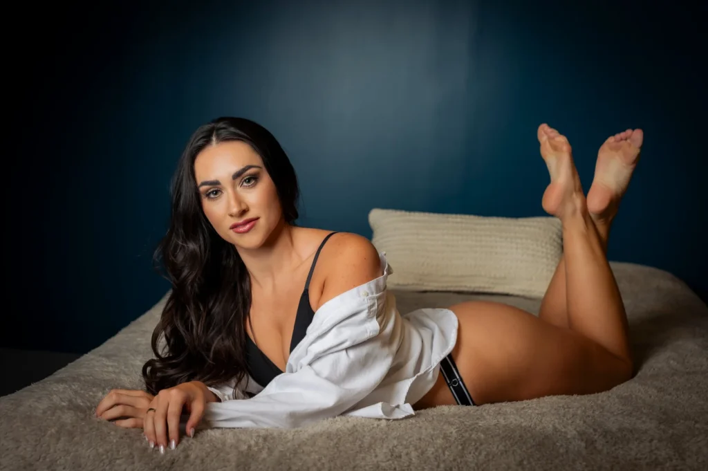 Reclining studio portrait in a white shirt