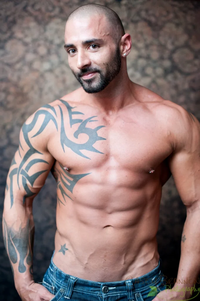 Studio portrait of a man with tattoos