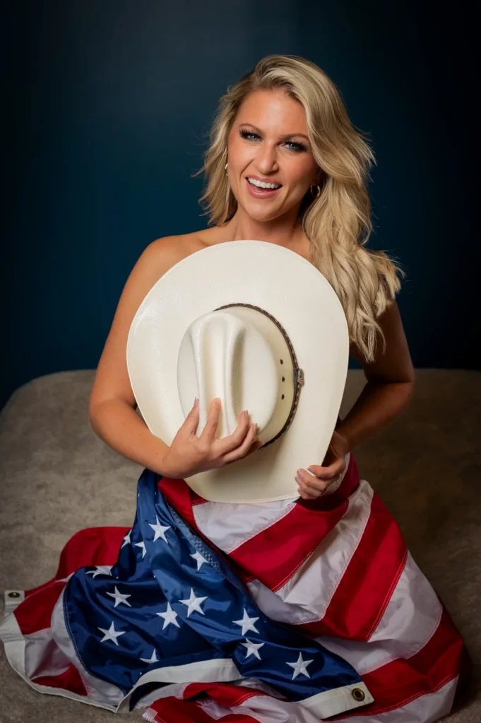 Studio portrait holding a white hat