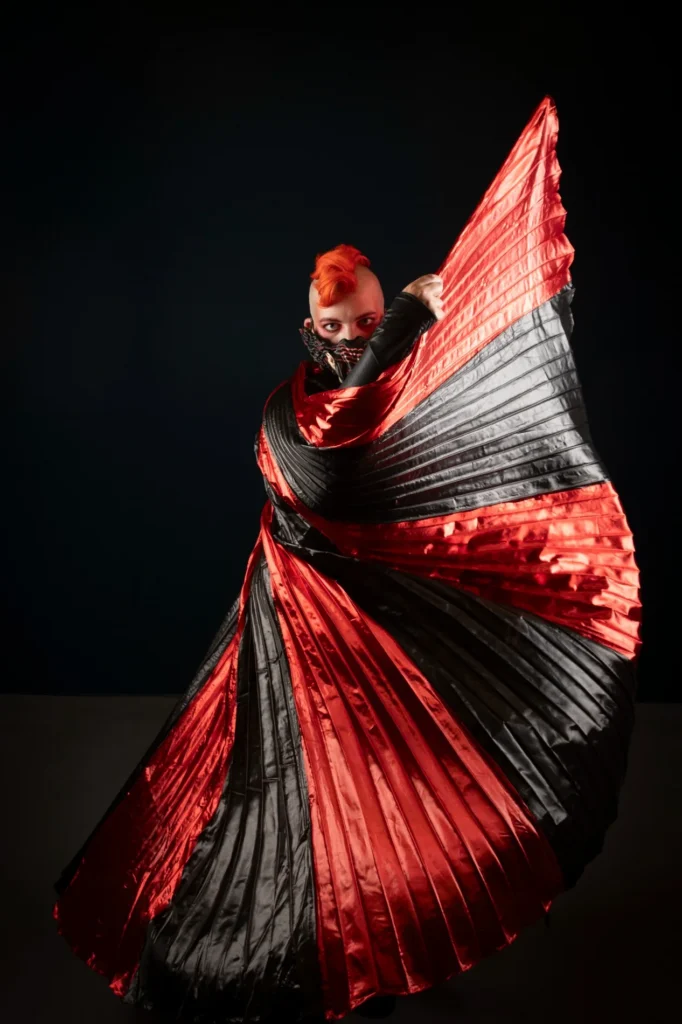 Creative portrait with flowing red and black fabric
