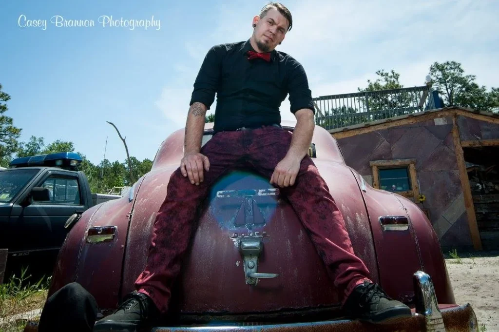 Outdoor portrait seated on a vintage car