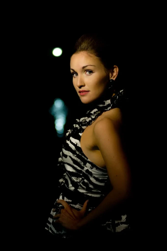 Dramatically lit portrait against a dark background