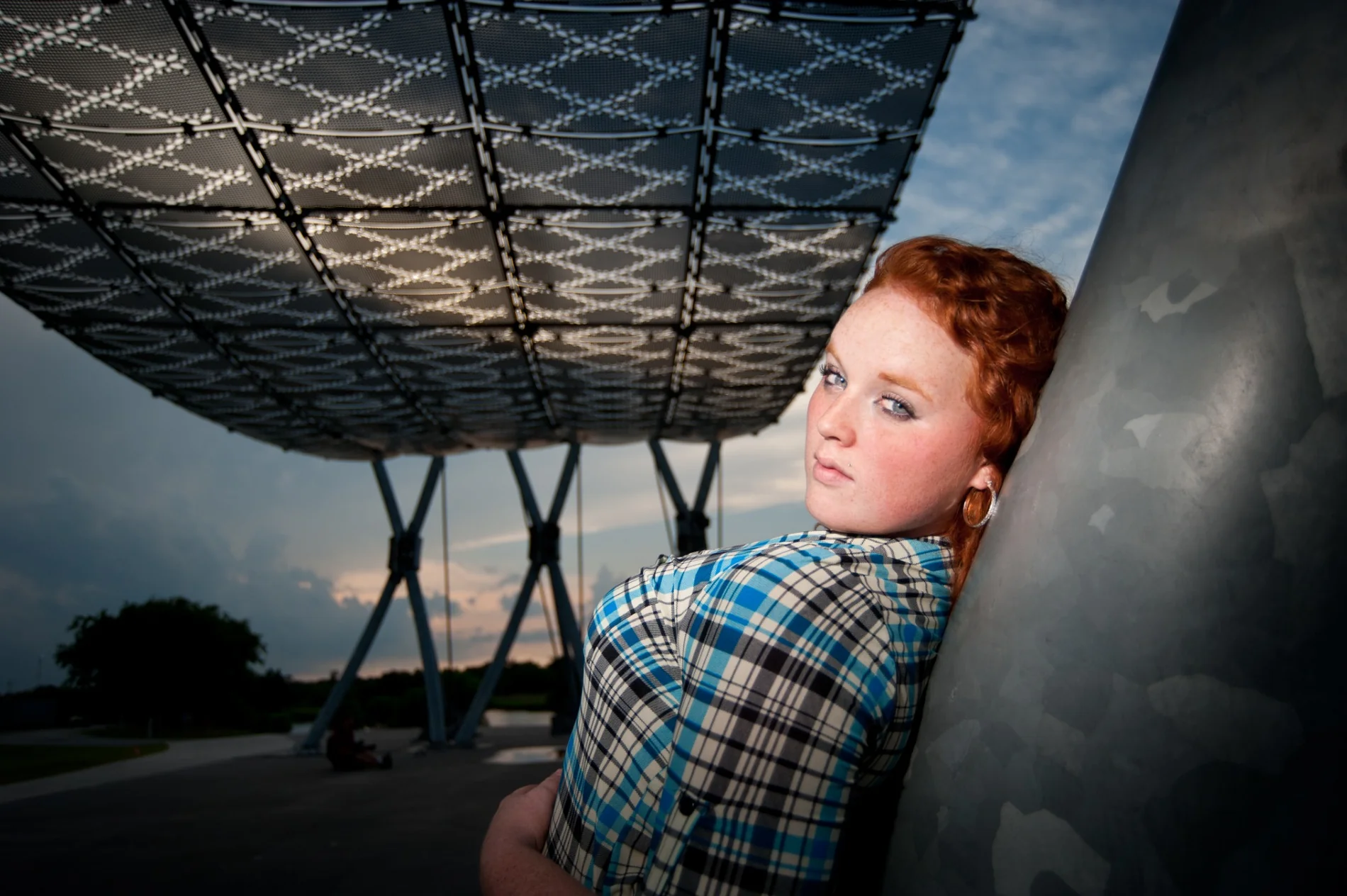 Portrait beneath a pier with a checked shirt