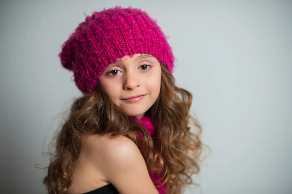 Portrait wearing a bright pink knit hat