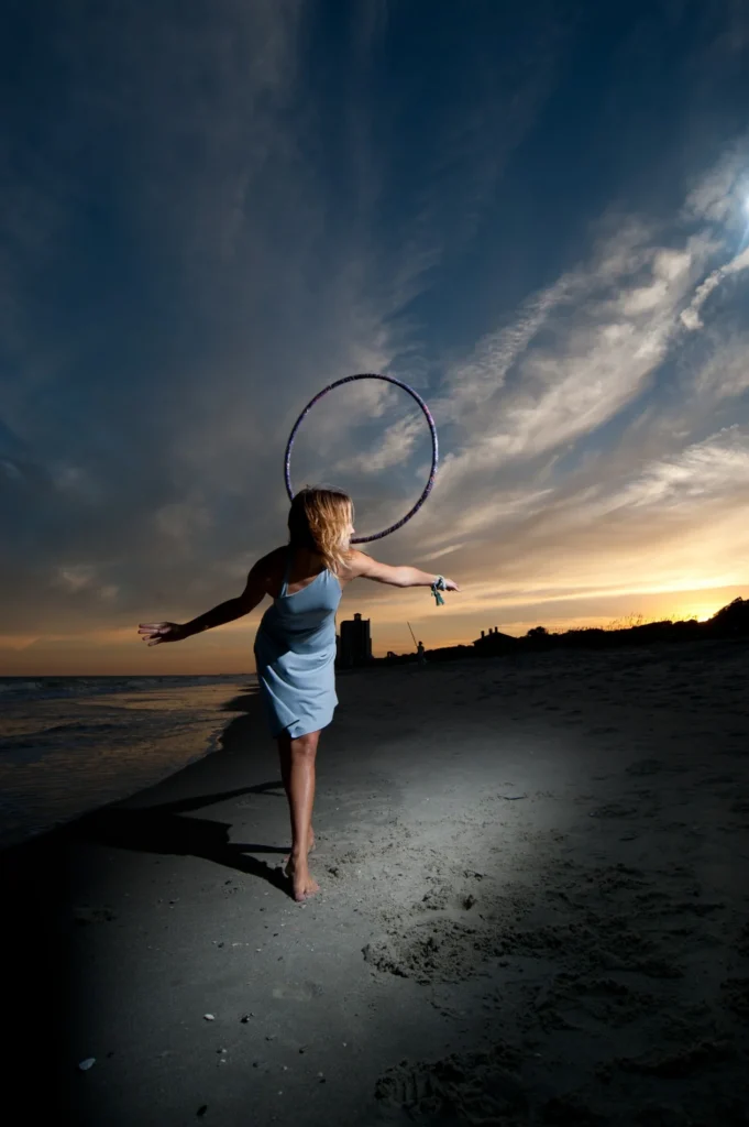 Portrait with a hoop beneath an evening sky
