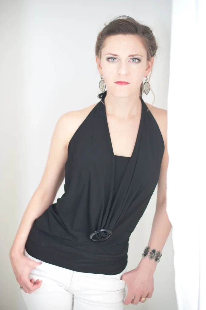 Studio portrait in black against a pale backdrop