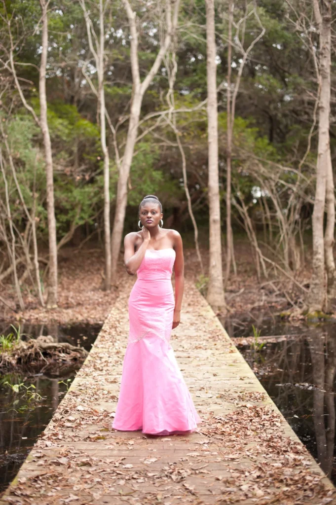 Outdoor portrait in a pink gown among trees