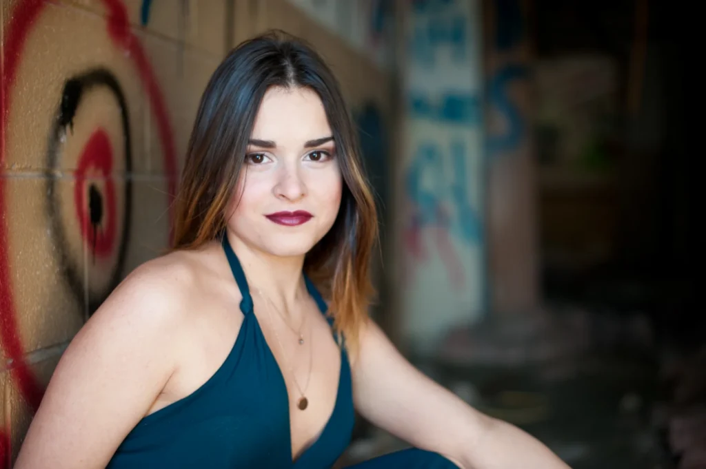 Senior portrait beside a colorful painted wall