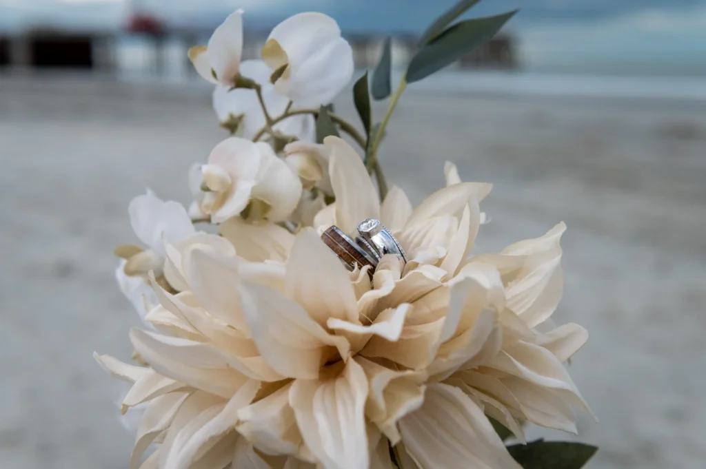 White bridal bouquet photographed on the beach