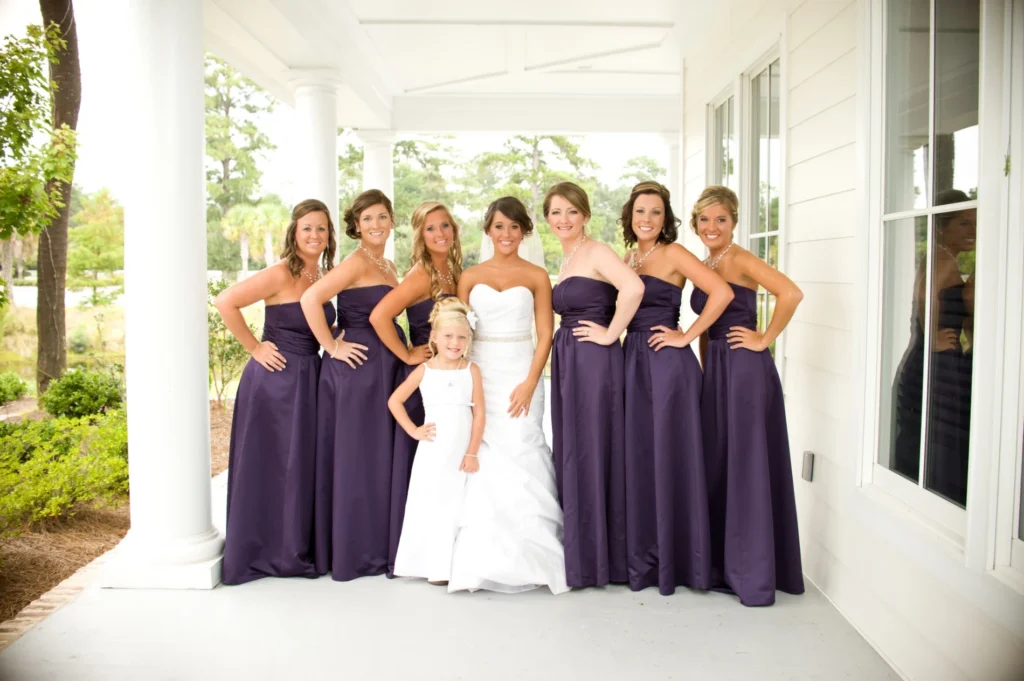 Bride with bridesmaids wearing purple dresses