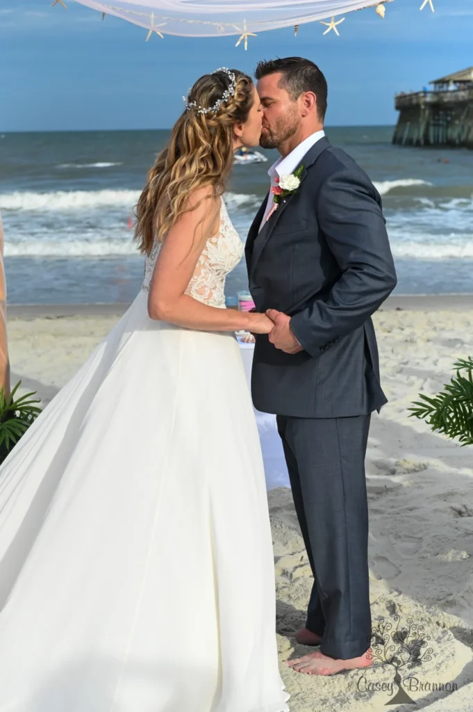 Newlyweds sharing a kiss outdoors