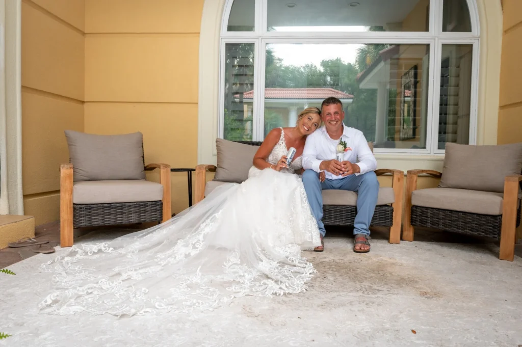 Bride and groom seated together on a porch