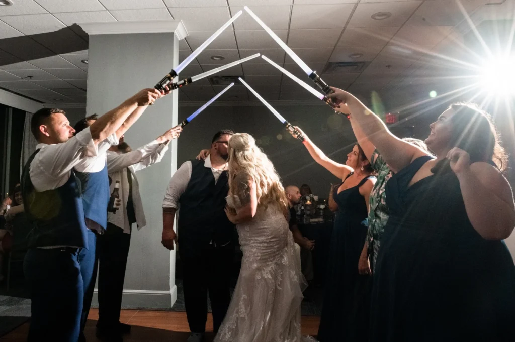Wedding celebration beneath an arch of raised lightsabers