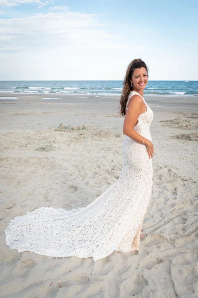 Bride looking back over her shoulder on the beach