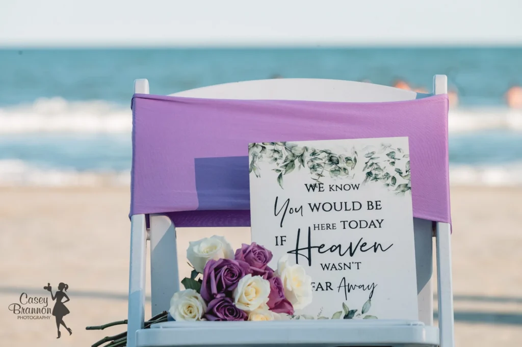 Wedding memorial chair with a sign and flowers
